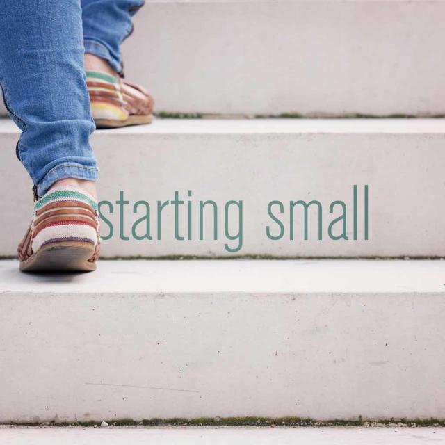Feet walking up stairs with text saying "starting small"