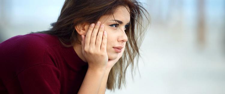 woman sitting with head in hands