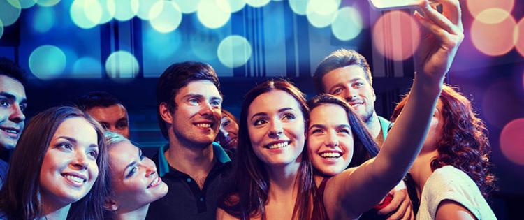 Group of teens gathered together to take a selfie