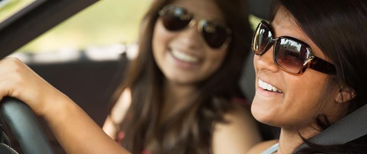 Two young women driving in car