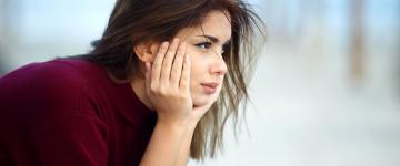 woman sitting with head in hands