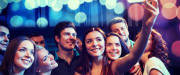 Group of teens gathered together to take a selfie